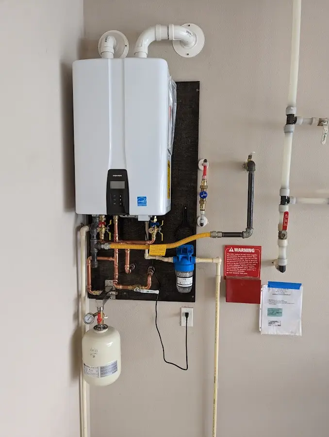 Professional plumber installing copper piping in a Moore home